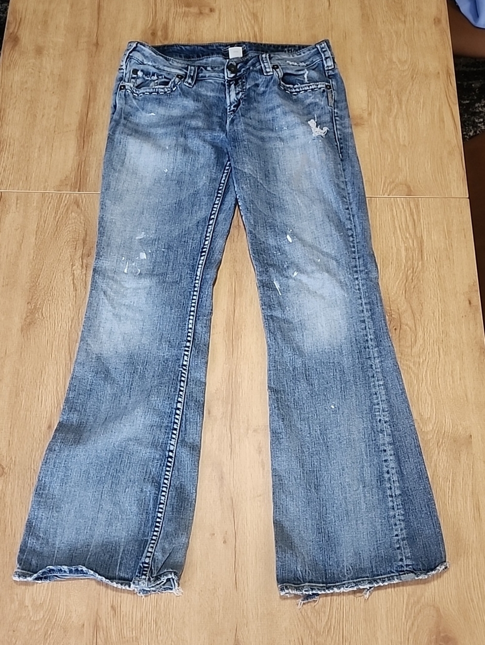 Silver Jeans Women's Blue Flare Jeans with Subtle Paint Splatter